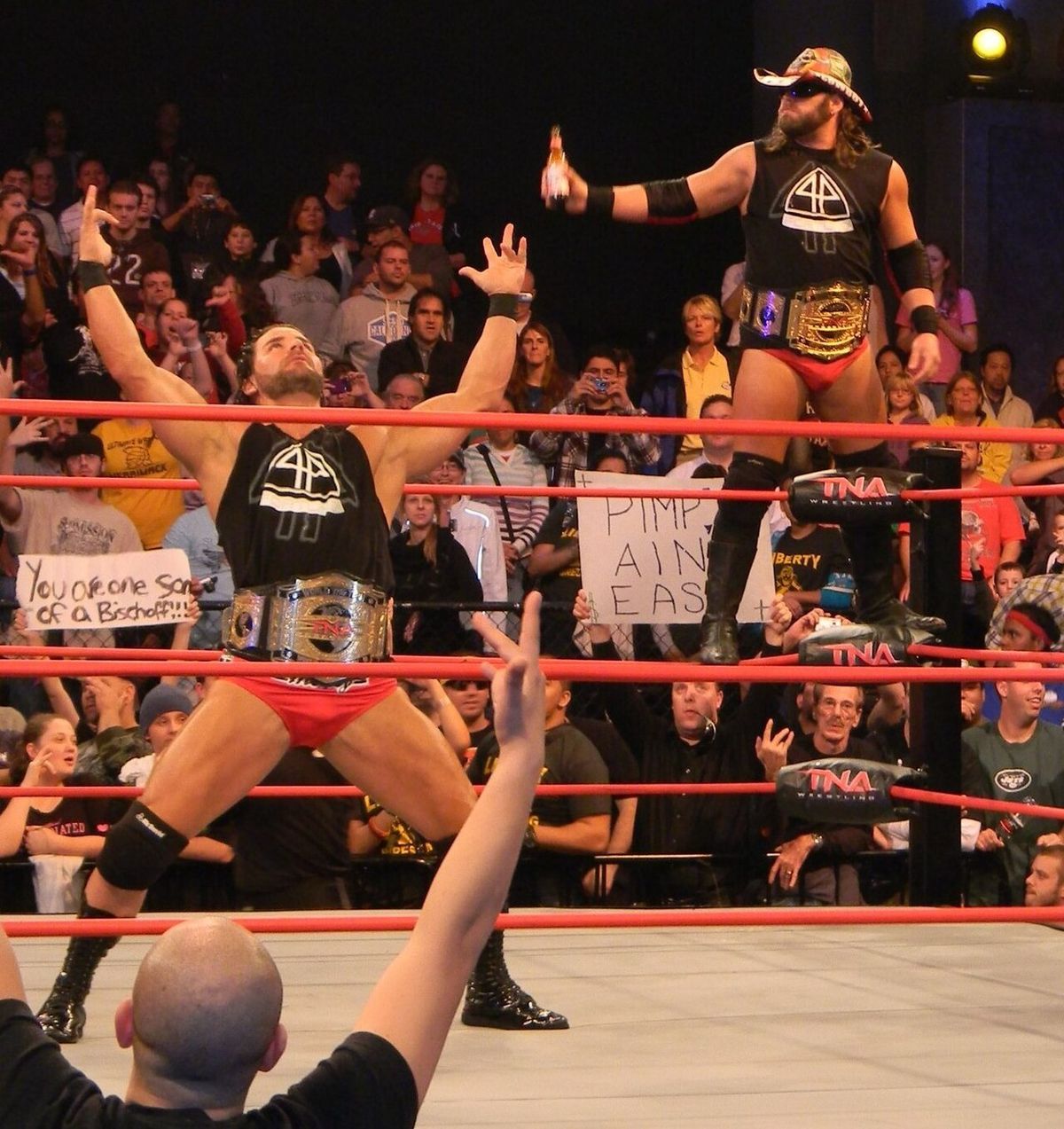Beer Money poses wearing the TNA World Tag Titles before a title defense on Impact.