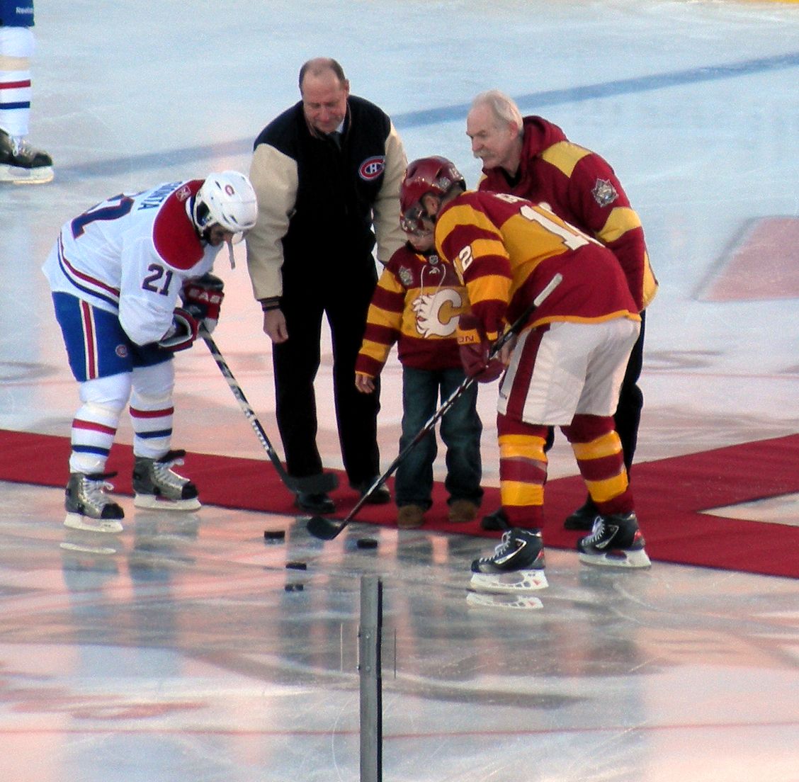 The ceremonial face off prior to the start of the 2011 Heritage Classic at McMahon Stadium in Calgary. Players are Calgary captain Jarome Ig