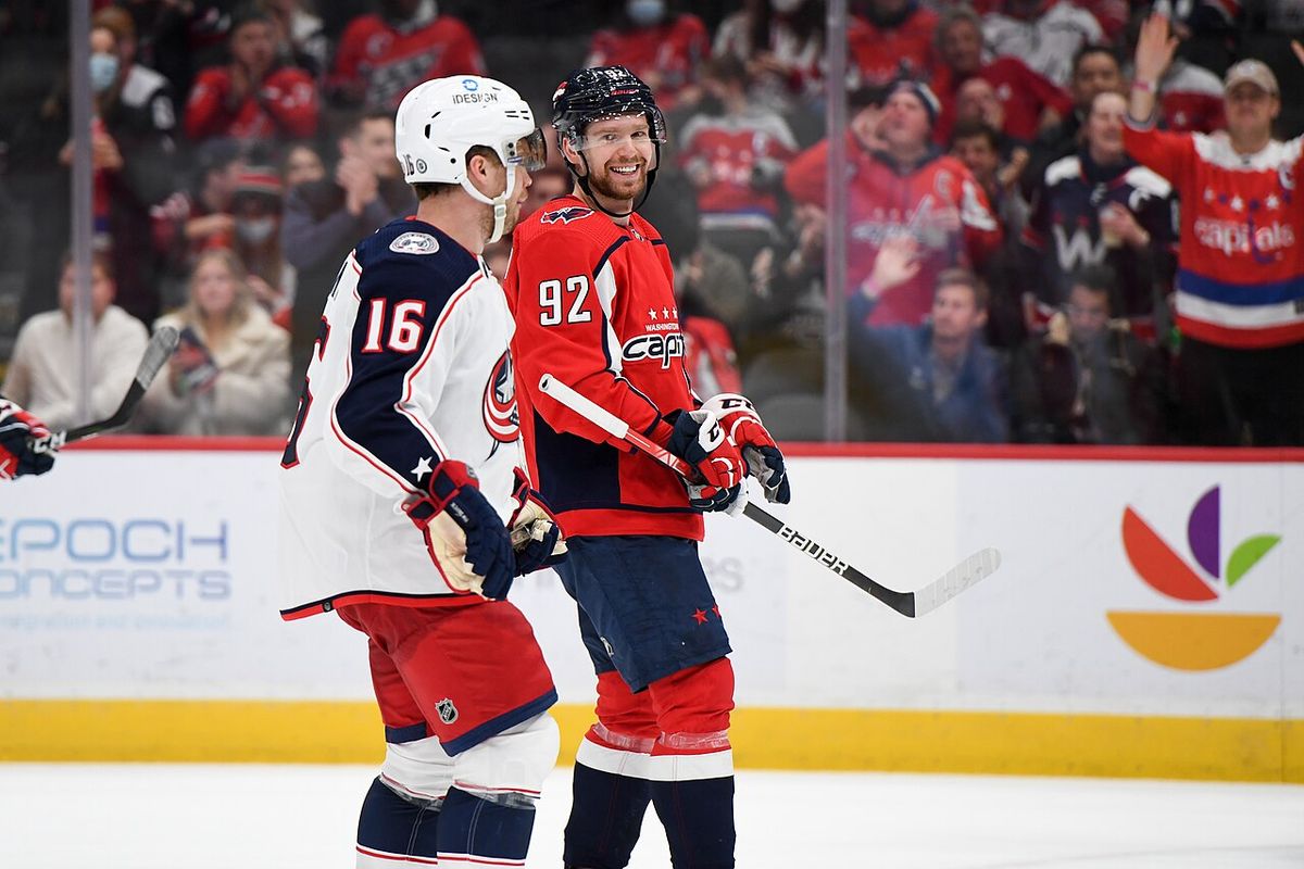 Washington Capitals Center Evgeny Kuznetsov (92) smiling at Columbus Blue Jackets Center Max Domi (16) during the 3rd period at Capital One 