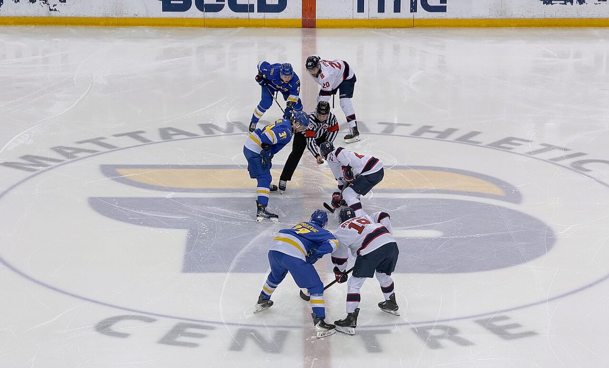 TMU Bold Captain Connor Bowie faces off against Brock Badgers forward Alexis Cournoyer at centre ice in the Mattamy Athletic Centre for the 