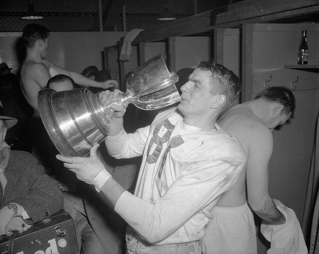 Don Getty, future Premier of Alberta, drinking out of the Grey Cup in the locker room at Varsity Stadium, Toronto, Ontario, Canada. The 44th